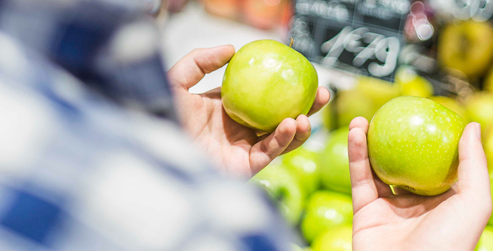 Man comparing apples. Similar imagery to comparing development technologies