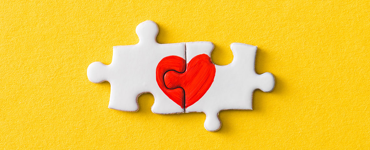 yellow connected puzzle pieces with a heart on them representing compatability